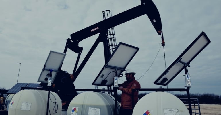 an oilfield chemical services worker installs tank monitoring automation